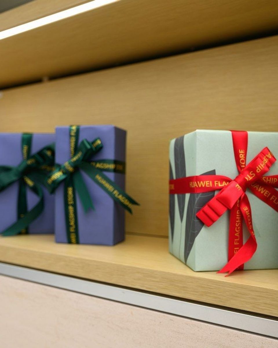 A row of wrapped presents sitting on a shelf