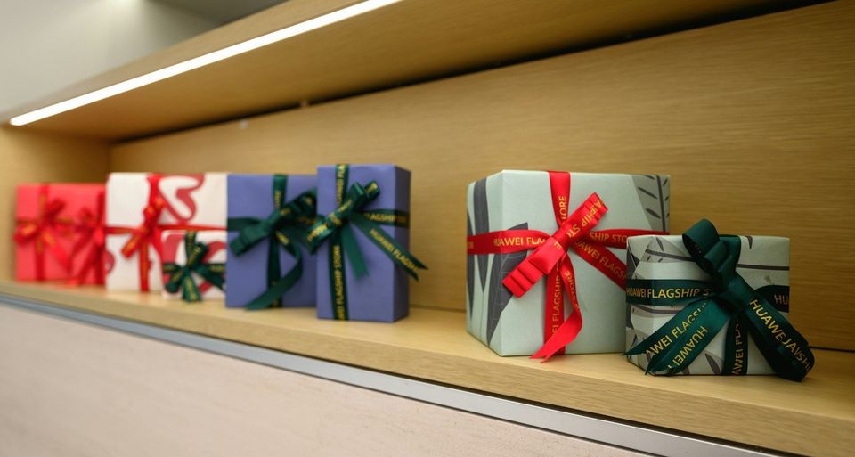 A row of wrapped presents sitting on a shelf