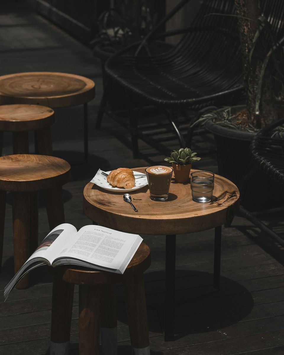 A latte and croissant on a cafe table