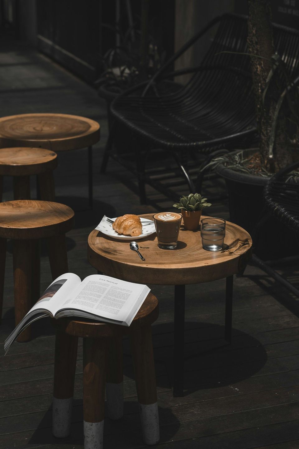 A latte and croissant on a cafe table